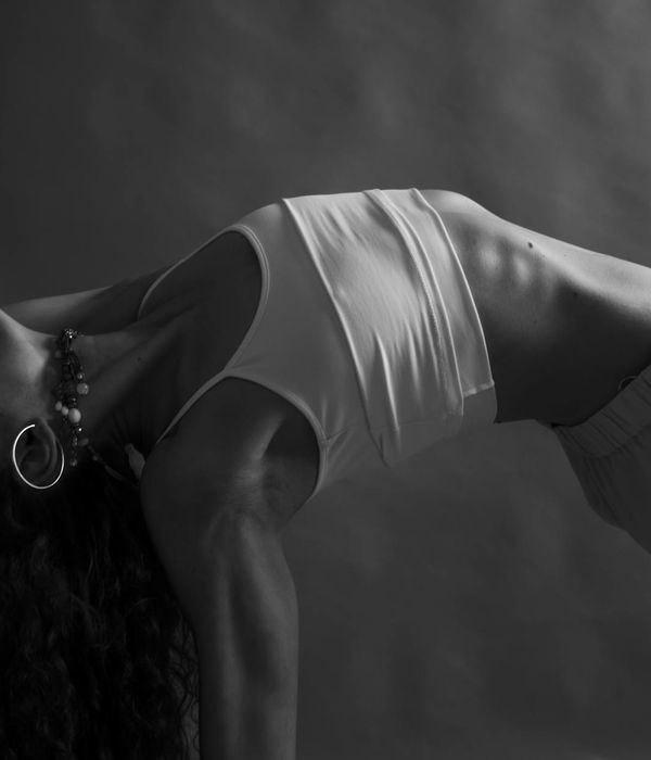 Woman in a graceful yoga pose showing flexibility and balance.